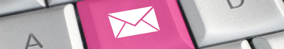 white envelope on a pink key on a white keyboard